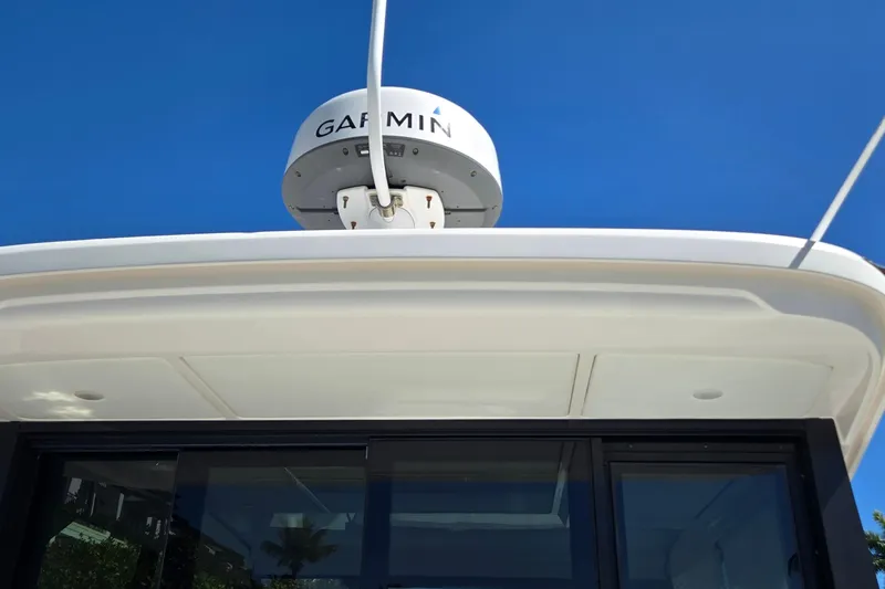  Yacht Photos Pics 2021 Regal 36 XO boat with Garmin radar against clear blue sky.