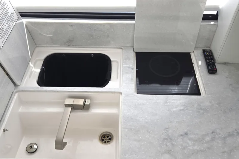  Yacht Photos Pics Modern kitchen area in 2021 Regal 36 XO yacht with sink and induction cooktop.