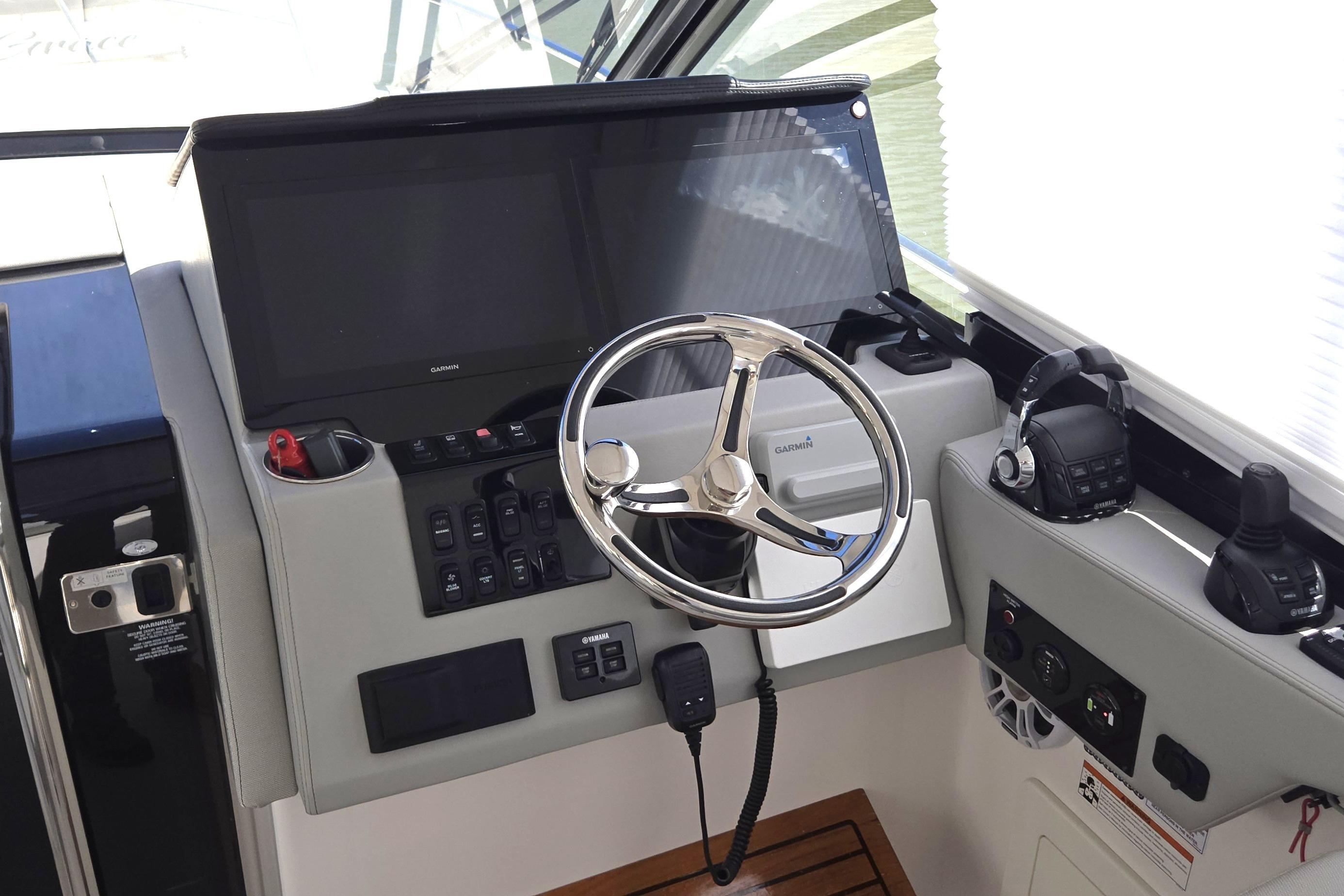 Helm of 2021 Regal 36 XO boat with steering wheel and navigation controls.