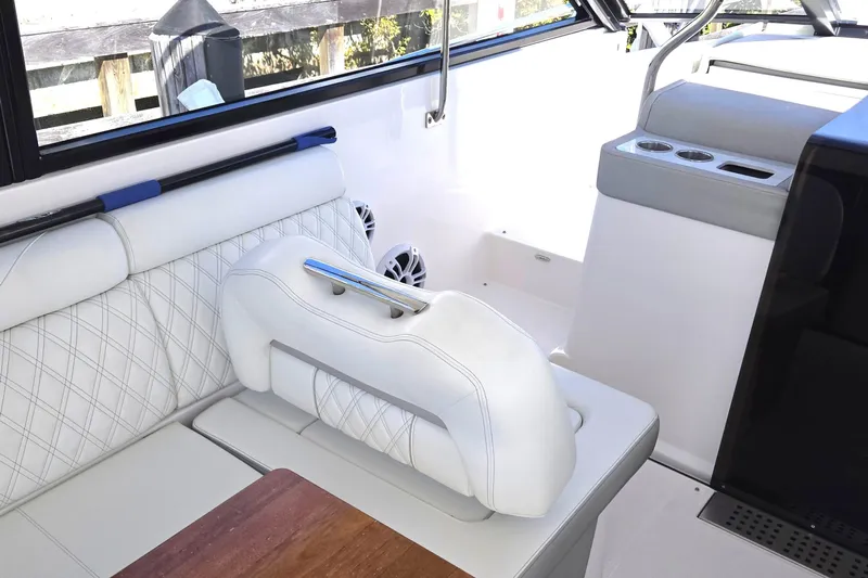  Yacht Photos Pics Interior of 2021 Regal 36 XO boat with white seating and cup holders.