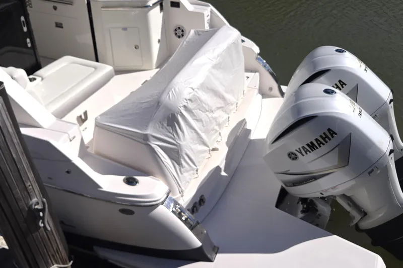  Yacht Photos Pics 2021 Regal 36 XO boat with Yamaha outboard engines, docked on calm water.