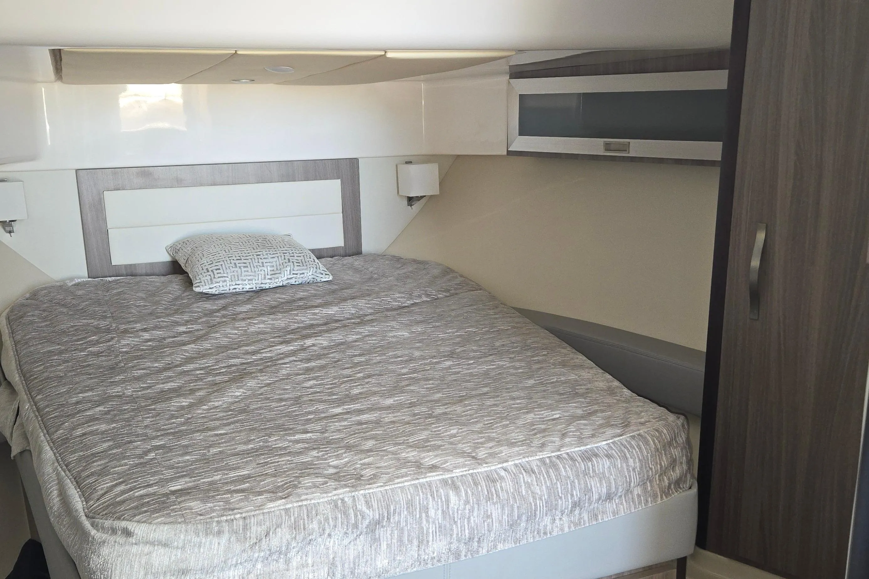 Interior cabin of 2021 Regal 36 XO yacht with a cozy bed and modern design.