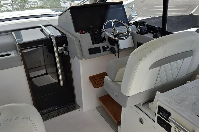  Yacht Photos Pics 2021 Regal 36 XO boat interior with helm, steering wheel, and seating.
