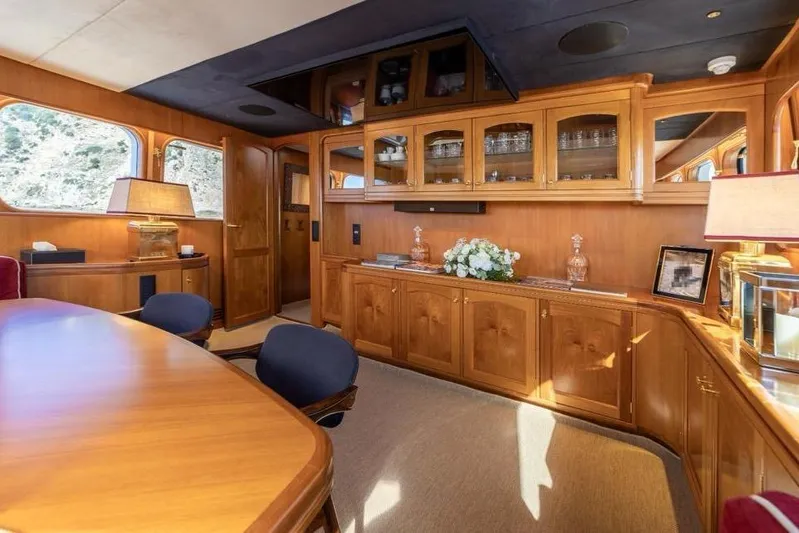  Yacht Photos Pics Luxurious interior of 1986 Moonen 85 yacht with elegant wood cabinetry and dining area.