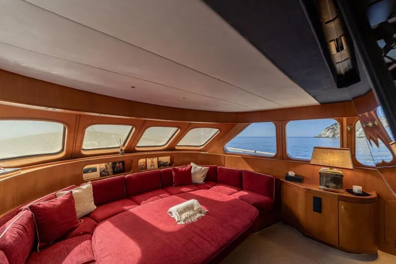  Yacht Photos Pics Luxurious interior of 1986 Moonen 85 yacht with red seating and ocean view.