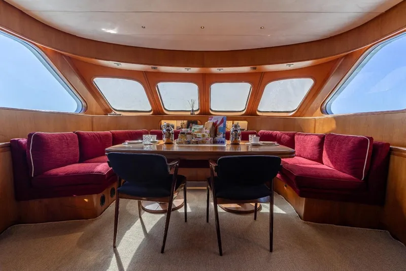  Yacht Photos Pics Luxurious interior of 1986 Moonen 85 yacht with elegant dining area and panoramic windows.