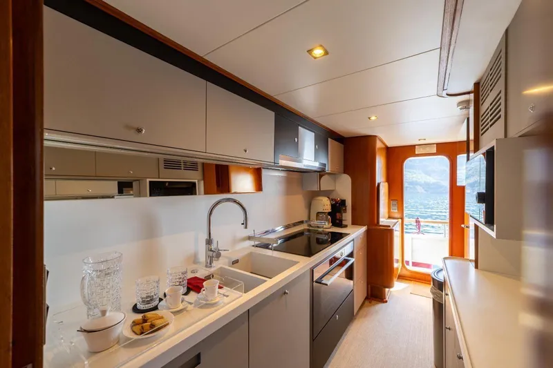  Yacht Photos Pics Luxurious kitchen interior of a 1986 Moonen 85 yacht with modern amenities.