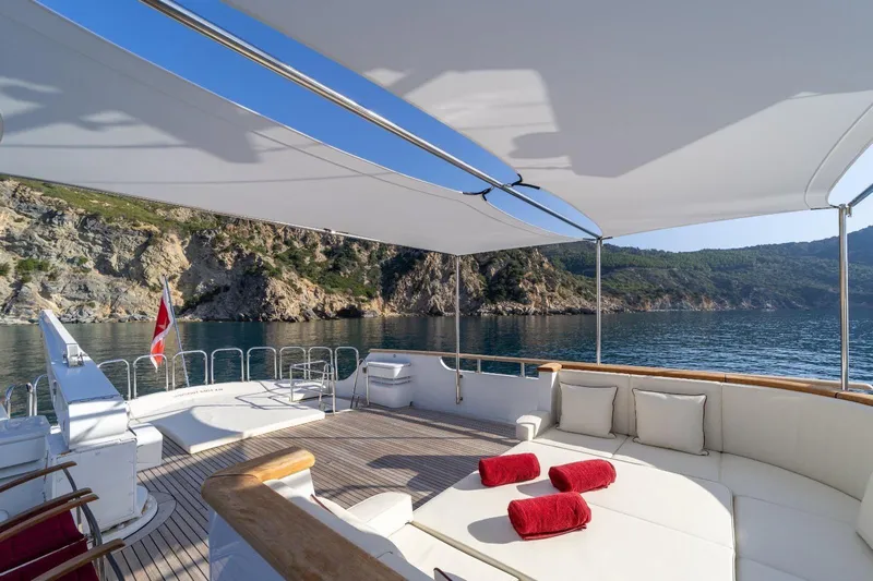  Yacht Photos Pics Luxurious 1986 Moonen 85 yacht deck with scenic coastal view and comfortable seating.