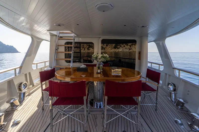  Yacht Photos Pics Luxurious 1986 Moonen 85 yacht deck with elegant dining area and ocean view.