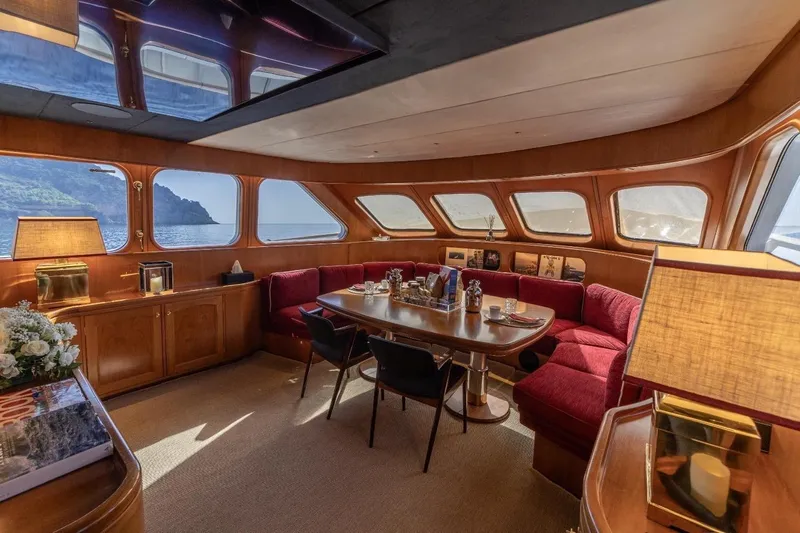  Yacht Photos Pics Luxurious interior of 1986 Moonen 85 yacht with elegant dining area and scenic ocean views.