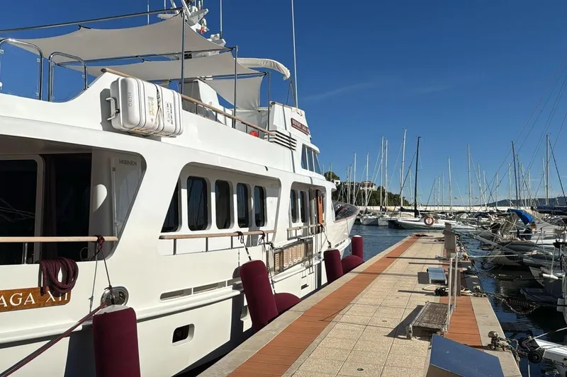  Yacht Photos Pics Luxury 1986 Moonen 85 yacht docked at marina under clear blue sky.