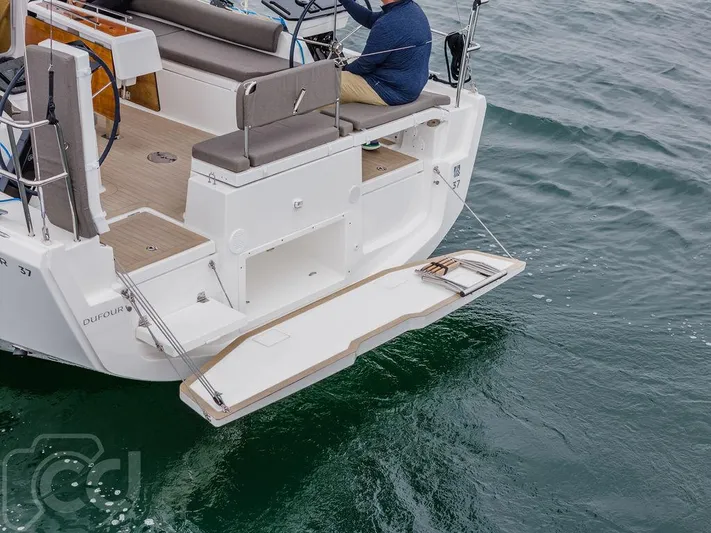 In Stock #042 Yacht Photos Pics 2023 Dufour 37 yacht with open swim platform on calm water.