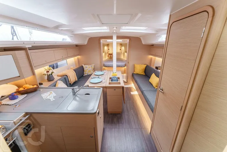 In Stock #042 Yacht Photos Pics Interior of 2023 Dufour 37 yacht, featuring modern kitchen and cozy seating area.