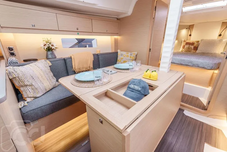 In Stock #042 Yacht Photos Pics Modern interior of 2023 Dufour 37 yacht with cozy dining area and bedroom.