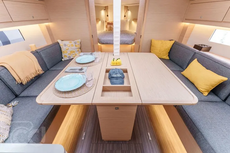In Stock #042 Yacht Photos Pics 2023 Dufour 37 yacht interior with cozy dining area and modern decor.