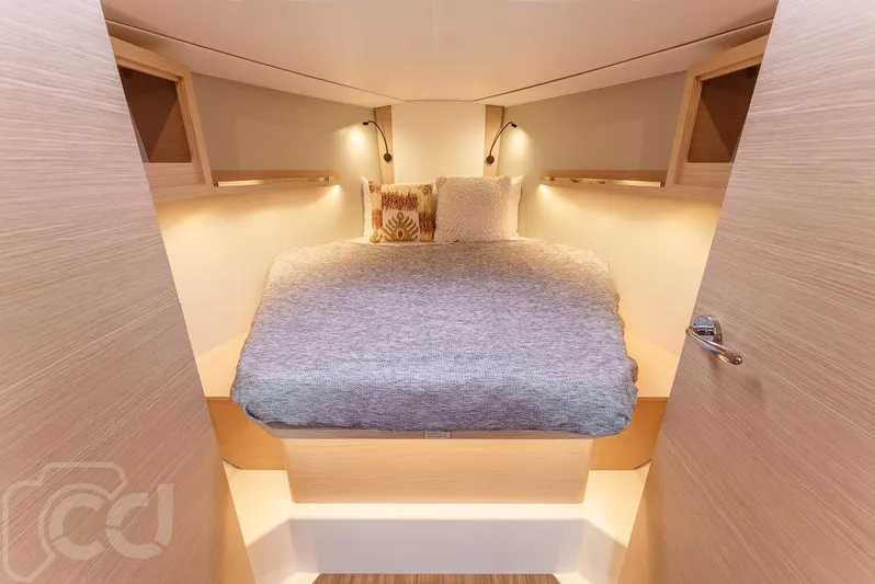 In Stock #042 Yacht Photos Pics Cozy cabin interior of 2023 Dufour 37 yacht with elegant bedding and ambient lighting.