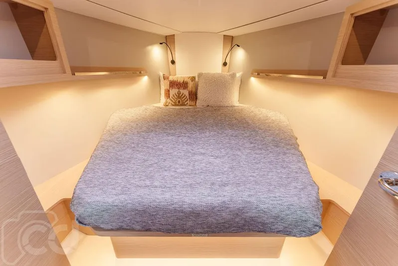 In Stock #042 Yacht Photos Pics Cozy cabin interior of 2023 Dufour 37 yacht with elegant bedding and ambient lighting.