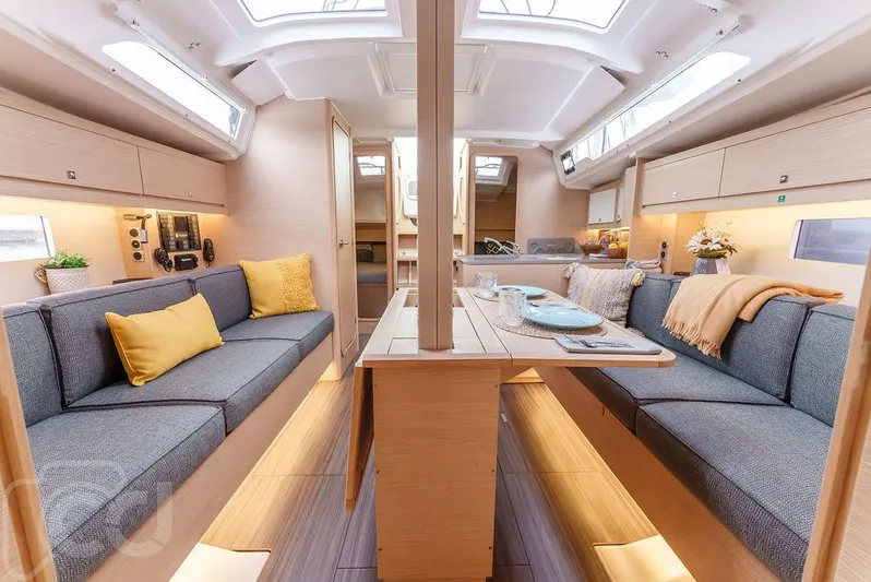 In Stock #042 Yacht Photos Pics 2023 Dufour 37 yacht interior with modern seating, dining table, and skylights.