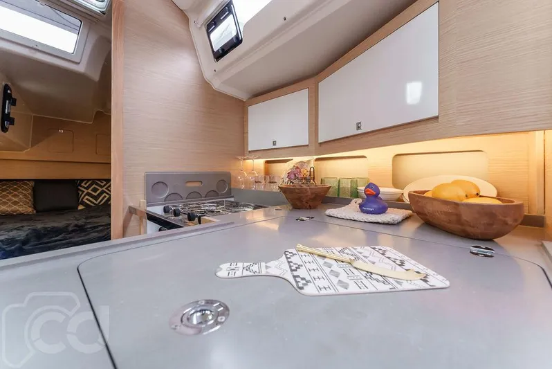 In Stock #042 Yacht Photos Pics Modern kitchen interior of 2023 Dufour 37 yacht with sleek design and ample storage.