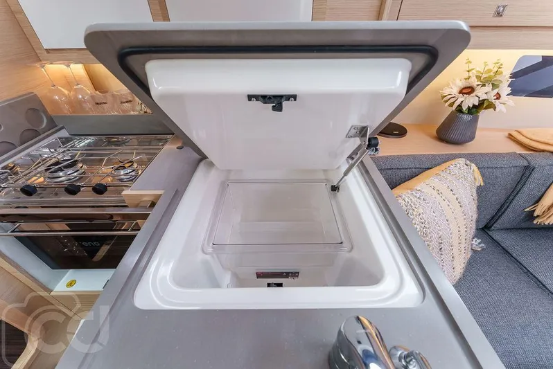 In Stock #042 Yacht Photos Pics Modern kitchen interior of 2023 Dufour 37 yacht with open fridge and stove.