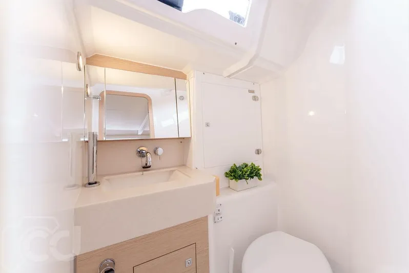 In Stock #042 Yacht Photos Pics Modern bathroom interior of 2023 Dufour 37 yacht, featuring sleek design and compact amenities.