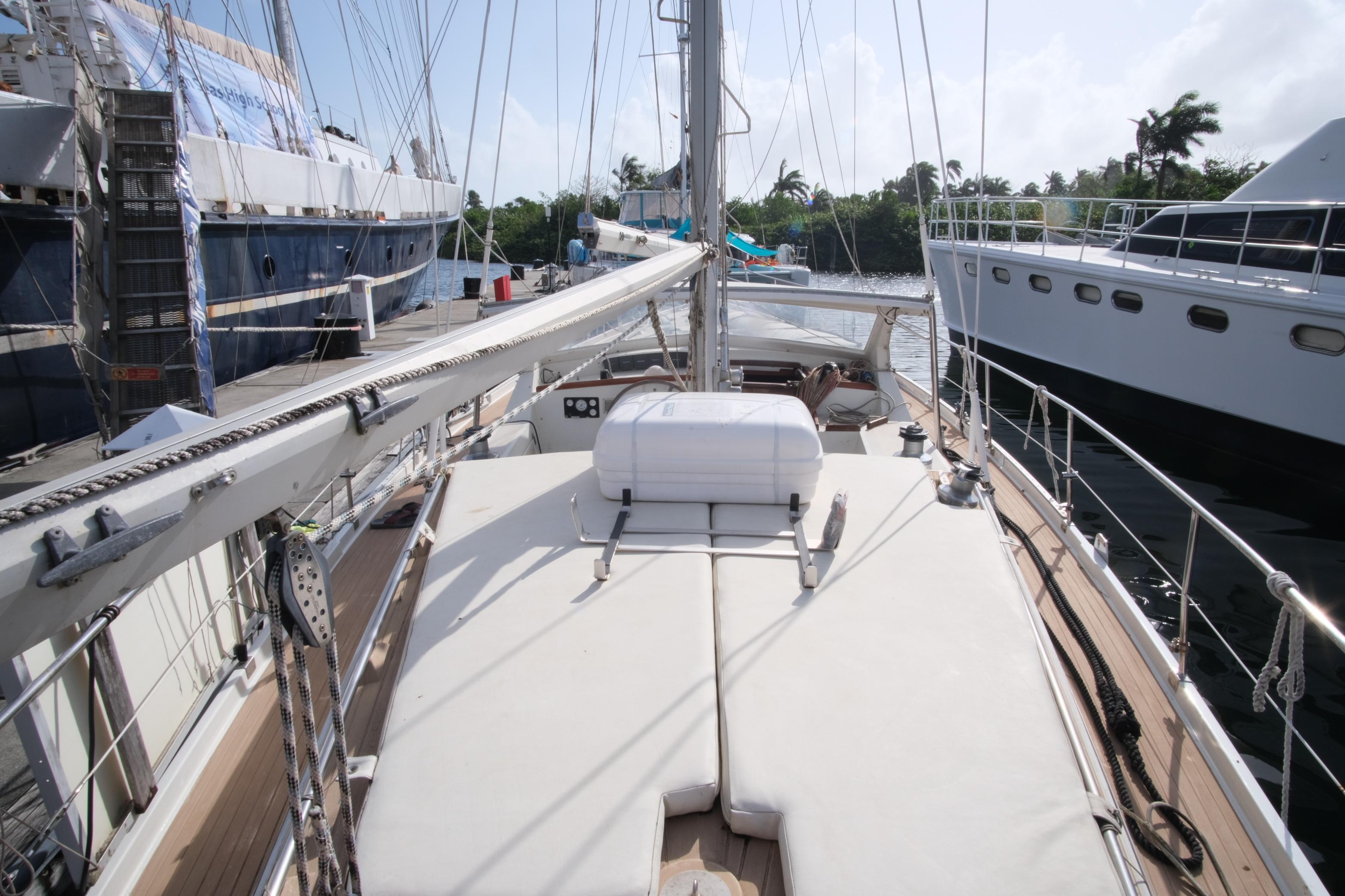 1984 Amel Maramu 45 sailboat deck view, docked alongside other yachts.