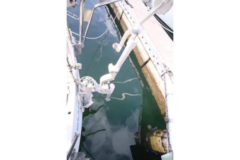 Blue Song Yacht Photos Pics Sailboat stern view, Amel Maramu 45, 1984, docked with visible water reflections.