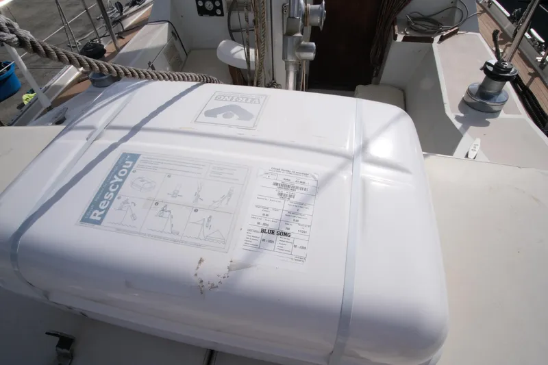 Blue Song Yacht Photos Pics Liferaft on 1984 Amel Maramu 45 sailboat deck, featuring RescYou instructions.
