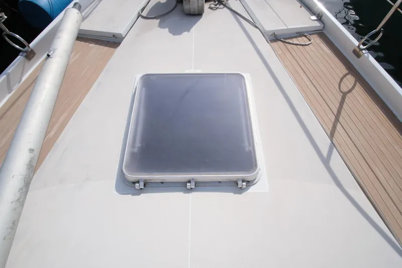 Blue Song Yacht Photos Pics Deck hatch of 1984 Amel Maramu 45 sailboat, featuring clean lines and teak accents.