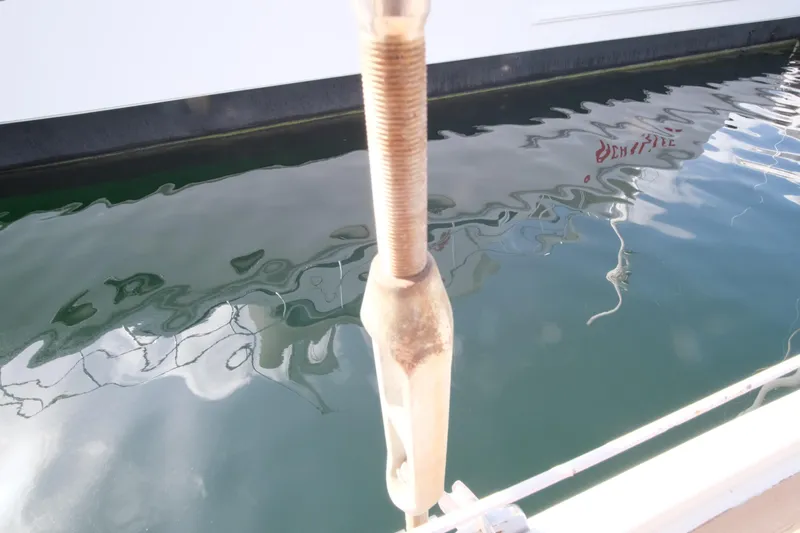 Blue Song Yacht Photos Pics Close-up of Amel Maramu 45 sailboat rigging, reflecting on calm water, 1984 model.