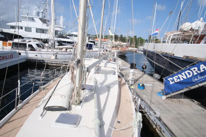 Blue Song Yacht Photos Pics 1984 Amel Maramu 45 sailboat docked in a marina, surrounded by other yachts.