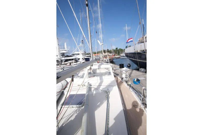 Blue Song Yacht Photos Pics 1984 Amel Maramu 45 sailboat docked at marina under clear blue sky.