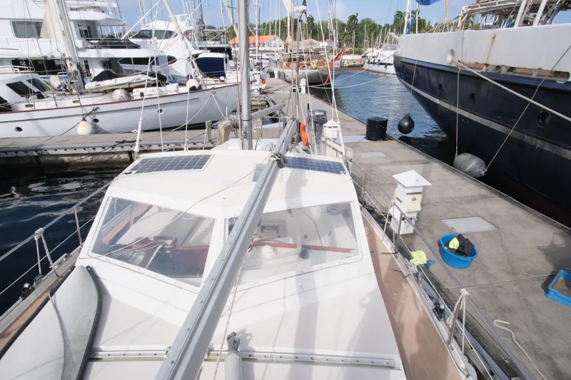 Blue Song Yacht Photos Pics 1984 Amel Maramu 45 sailboat docked at marina, surrounded by other boats.