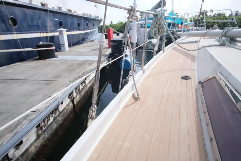Blue Song Yacht Photos Pics 1984 Amel Maramu 45 sailboat docked at marina, showing deck and mooring lines.