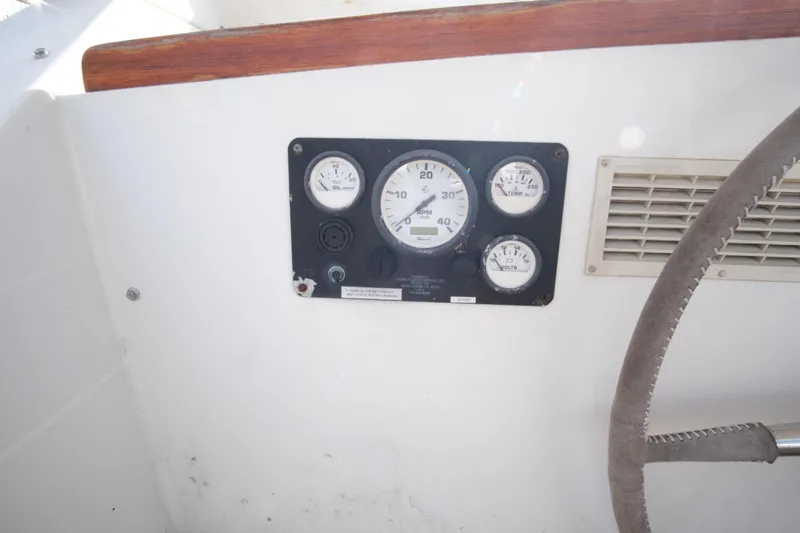 Blue Song Yacht Photos Pics Instrument panel of 1984 Amel Maramu 45 sailboat with gauges and steering wheel.