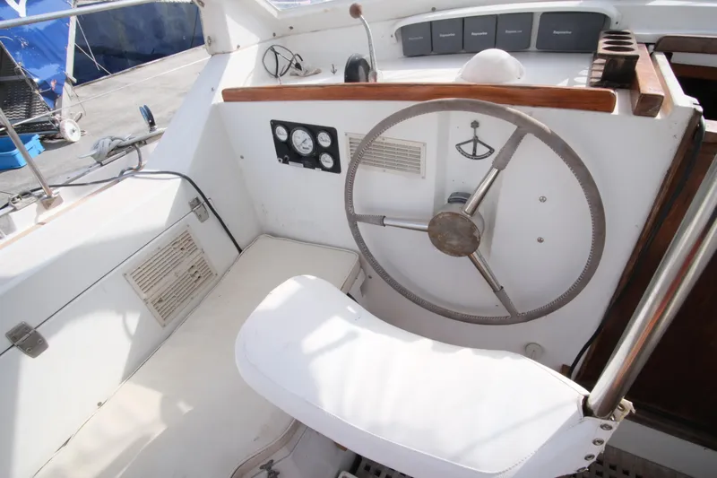 Blue Song Yacht Photos Pics Cockpit of 1984 Amel Maramu 45 sailboat with steering wheel and navigation instruments.
