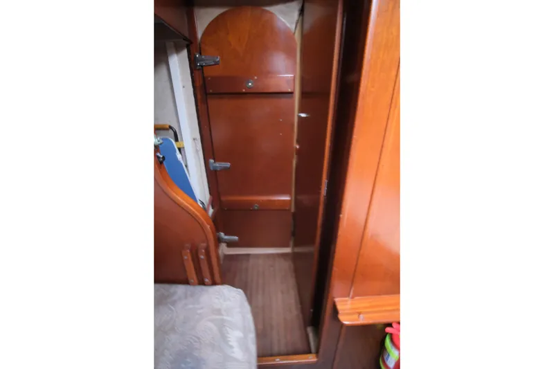 Blue Song Yacht Photos Pics Interior of 1984 Amel Maramu 45 sailboat with wooden cabinetry and cozy design.