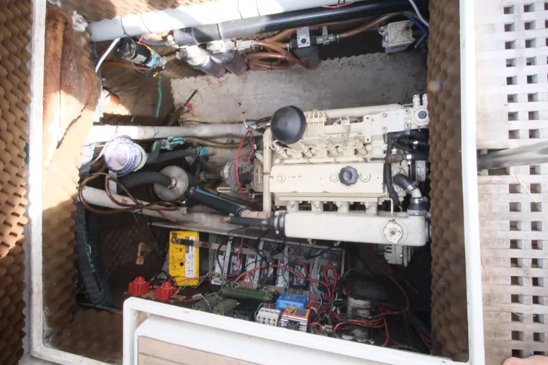 Blue Song Yacht Photos Pics Engine compartment of a 1984 Amel Maramu 45 sailboat, showing mechanical components and wiring.