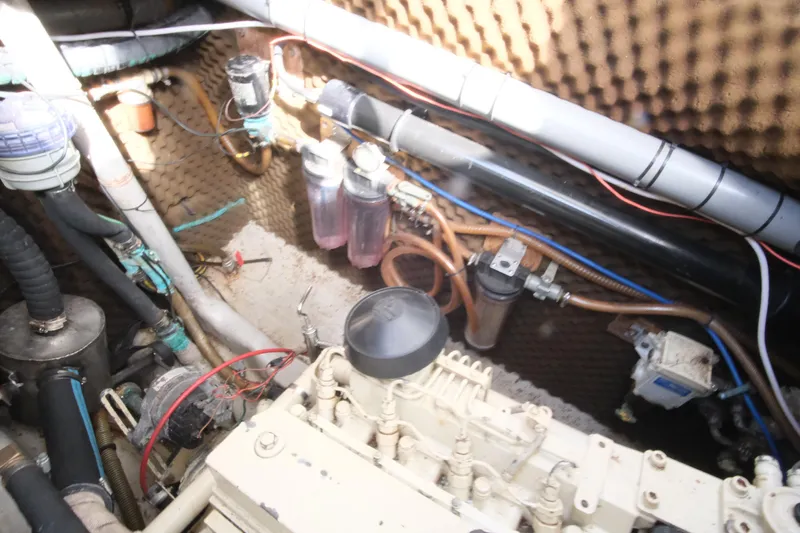 Blue Song Yacht Photos Pics Engine room of 1984 Amel Maramu 45 sailboat with visible pipes and filters.