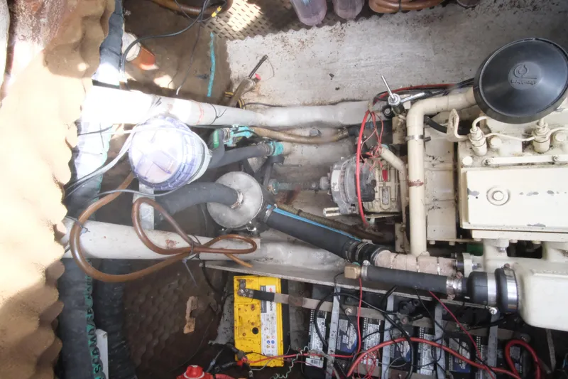 Blue Song Yacht Photos Pics Engine compartment of 1984 Amel Maramu 45 sailboat, showing mechanical components and wiring.