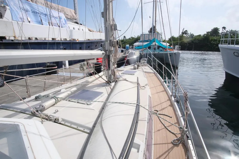 Blue Song Yacht Photos Pics 1984 Amel Maramu 45 sailboat docked in a marina, surrounded by other vessels.
