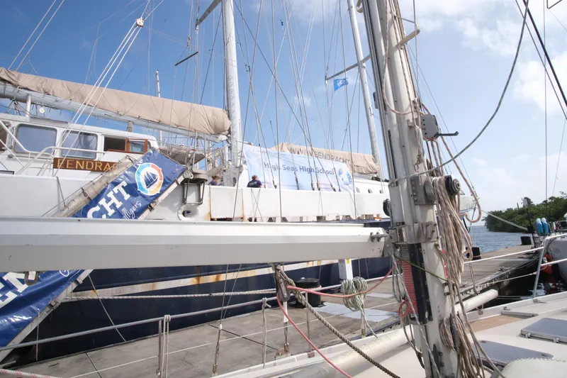 Blue Song Yacht Photos Pics Sailboat docked at marina, Amel Maramu 45, 1984 model, with banners and rigging visible.