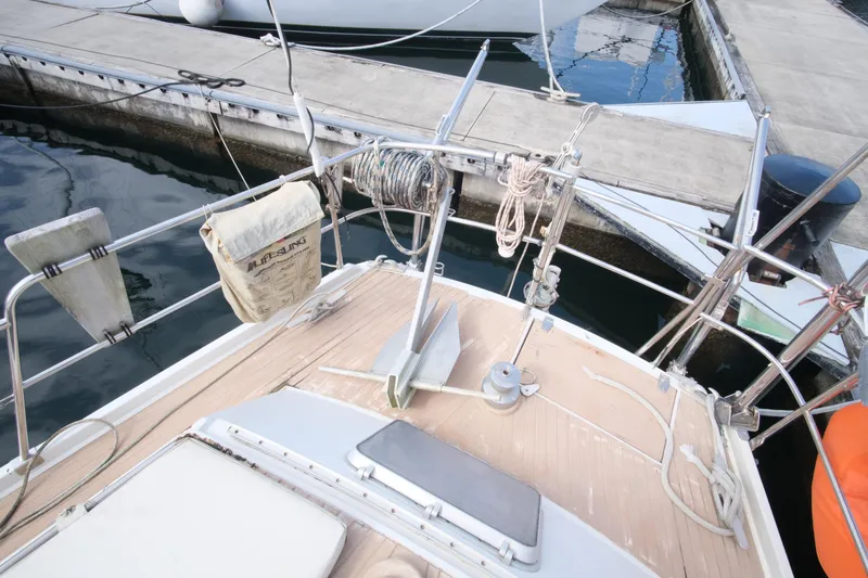 Blue Song Yacht Photos Pics 1984 Amel Maramu 45 sailboat deck with lifebuoy and mooring ropes at dock.