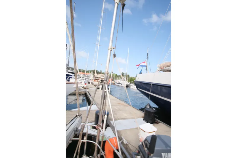 Blue Song Yacht Photos Pics Docked 1984 Amel Maramu 45 sailboat with clear blue sky background.