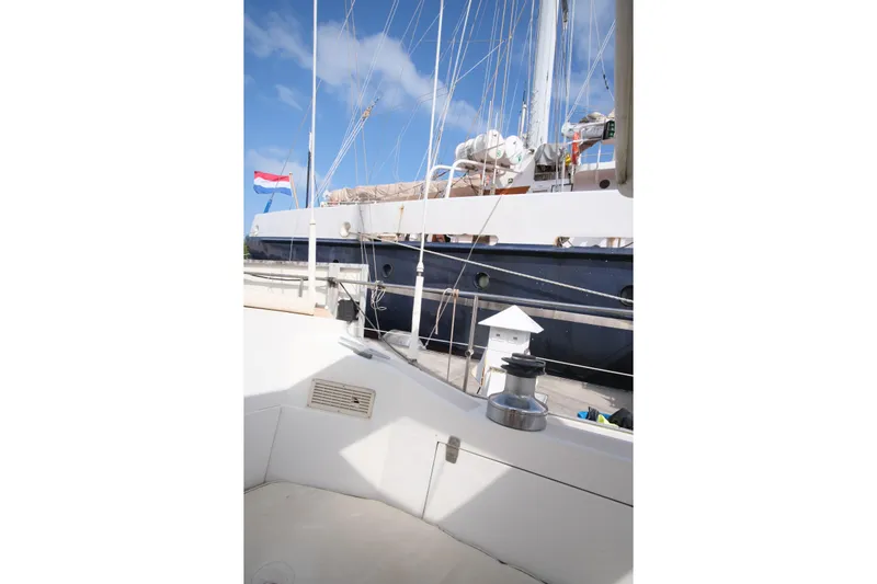 Blue Song Yacht Photos Pics 1984 Amel Maramu 45 sailboat deck with clear sky and nautical equipment.