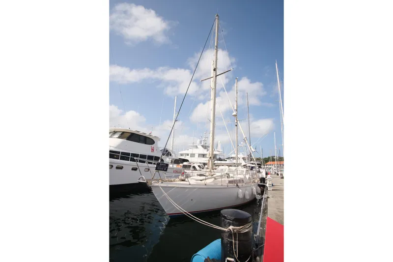 Blue Song Yacht Photos Pics 1984 Amel Maramu 45 sailboat docked at marina under blue sky.