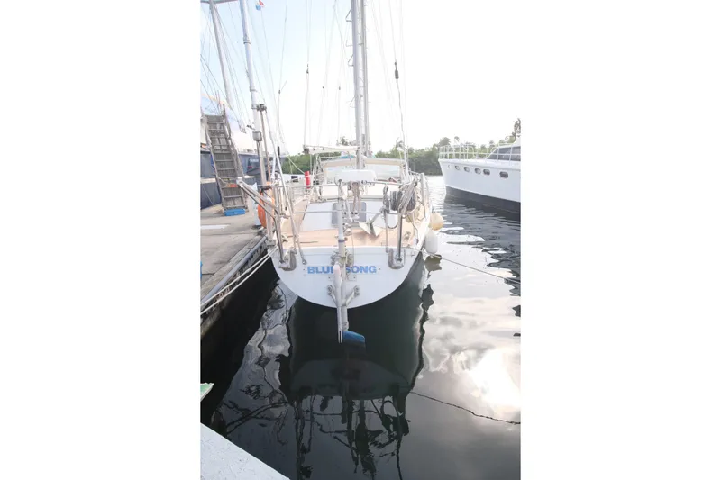 Blue Song Yacht Photos Pics 1984 Amel Maramu 45 sailboat docked in marina, rear view.