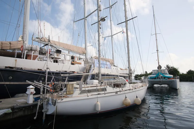 Blue Song Yacht Photos Pics 1984 Amel Maramu 45 sailboat docked alongside other vessels in a marina.