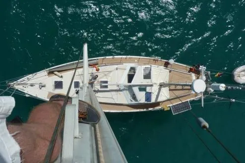 Blue Song Yacht Photos Pics Aerial view of 1984 Amel Maramu 45 sailboat on turquoise water.