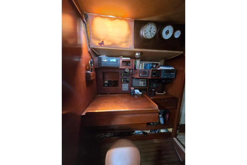 Blue Song Yacht Photos Pics Navigation station of 1984 Amel Maramu 45 yacht with wooden interior and instruments.